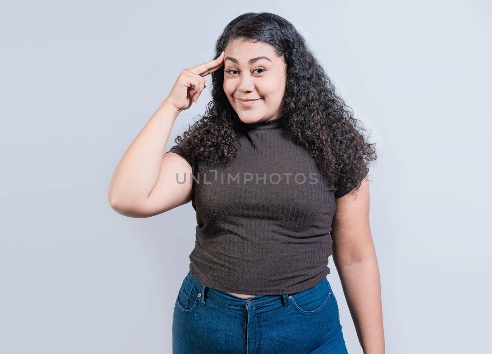 Woman thinking with finger on head isolated. Smiling people thinking with finger on head on white background by isaiphoto