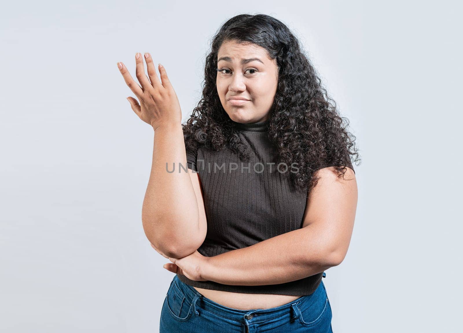 Puzzled woman gesturing with hand isolated. Girl with puzzled face frowning. Puzzled people making hand gestures by isaiphoto