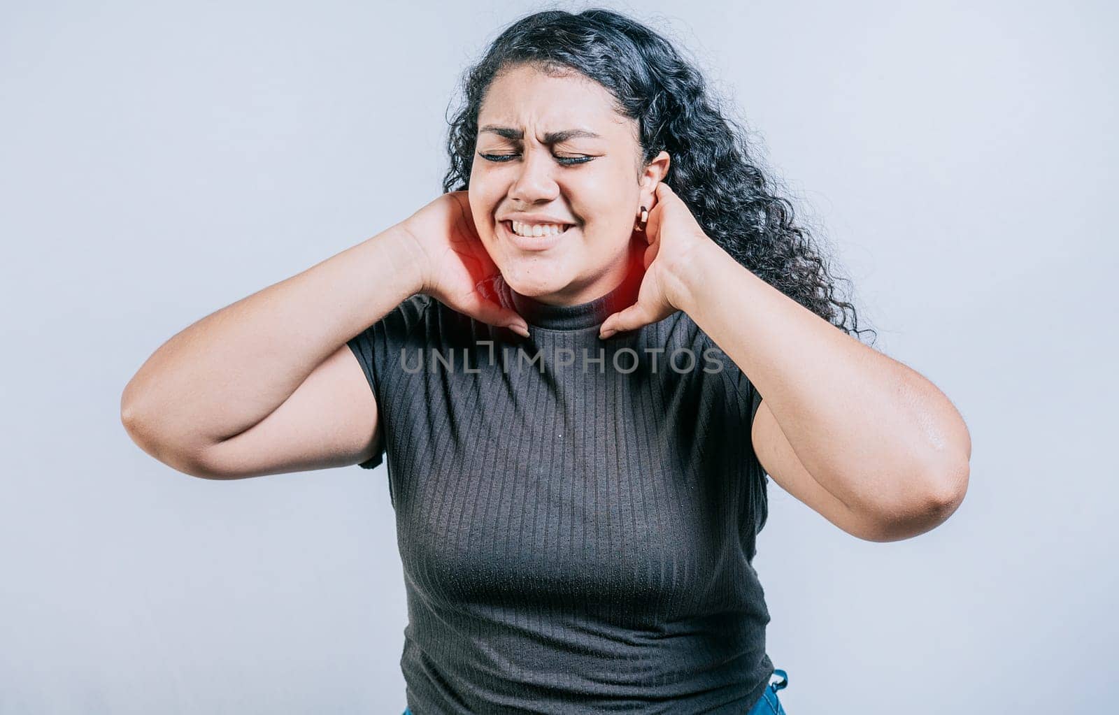 People with neck tension. Young woman suffering with neck pain. Neck pain and stress concept by isaiphoto