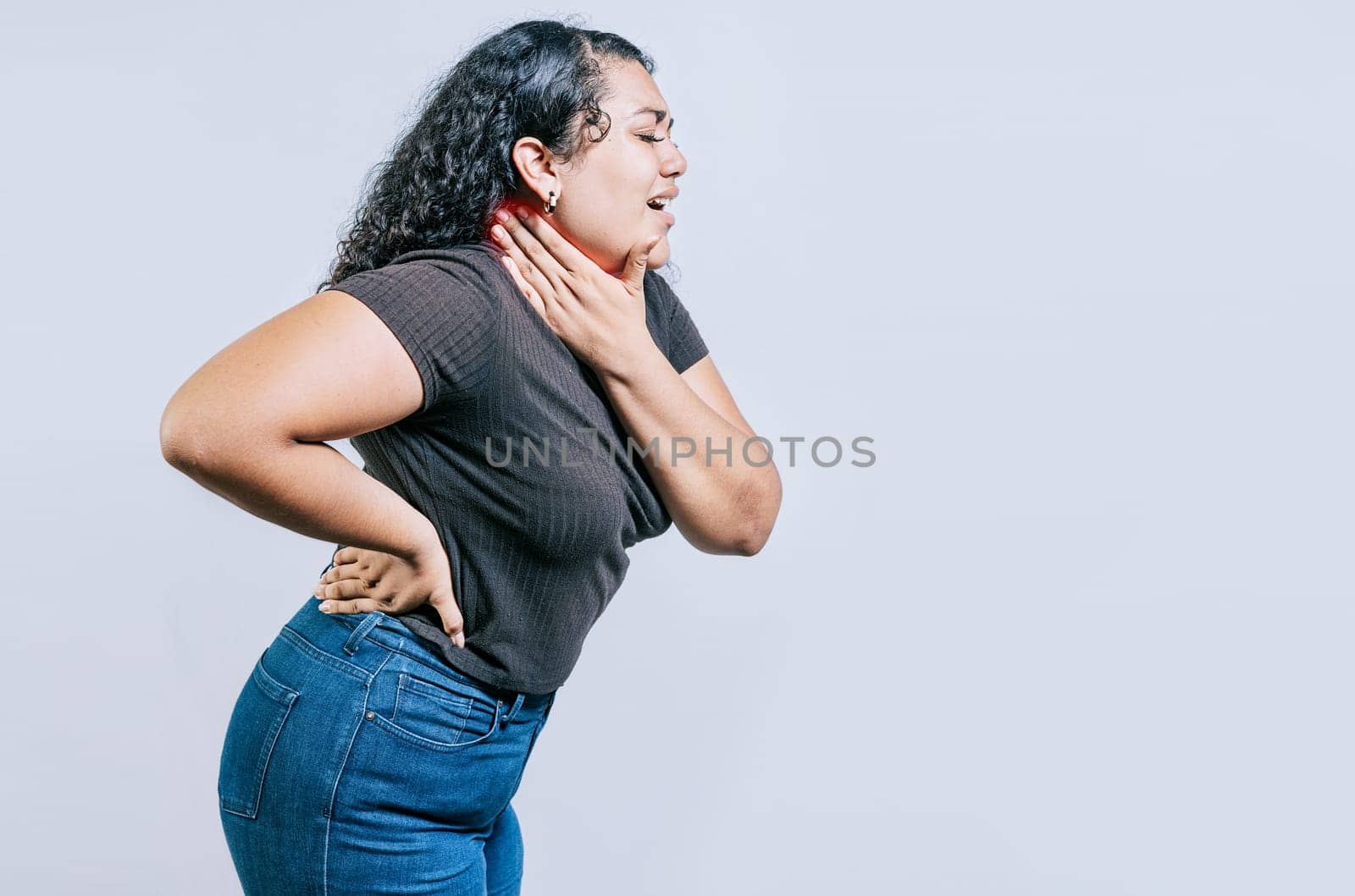 Neck pain and stress concept. Young girl suffering with neck pain isolated. People with neck tension by isaiphoto