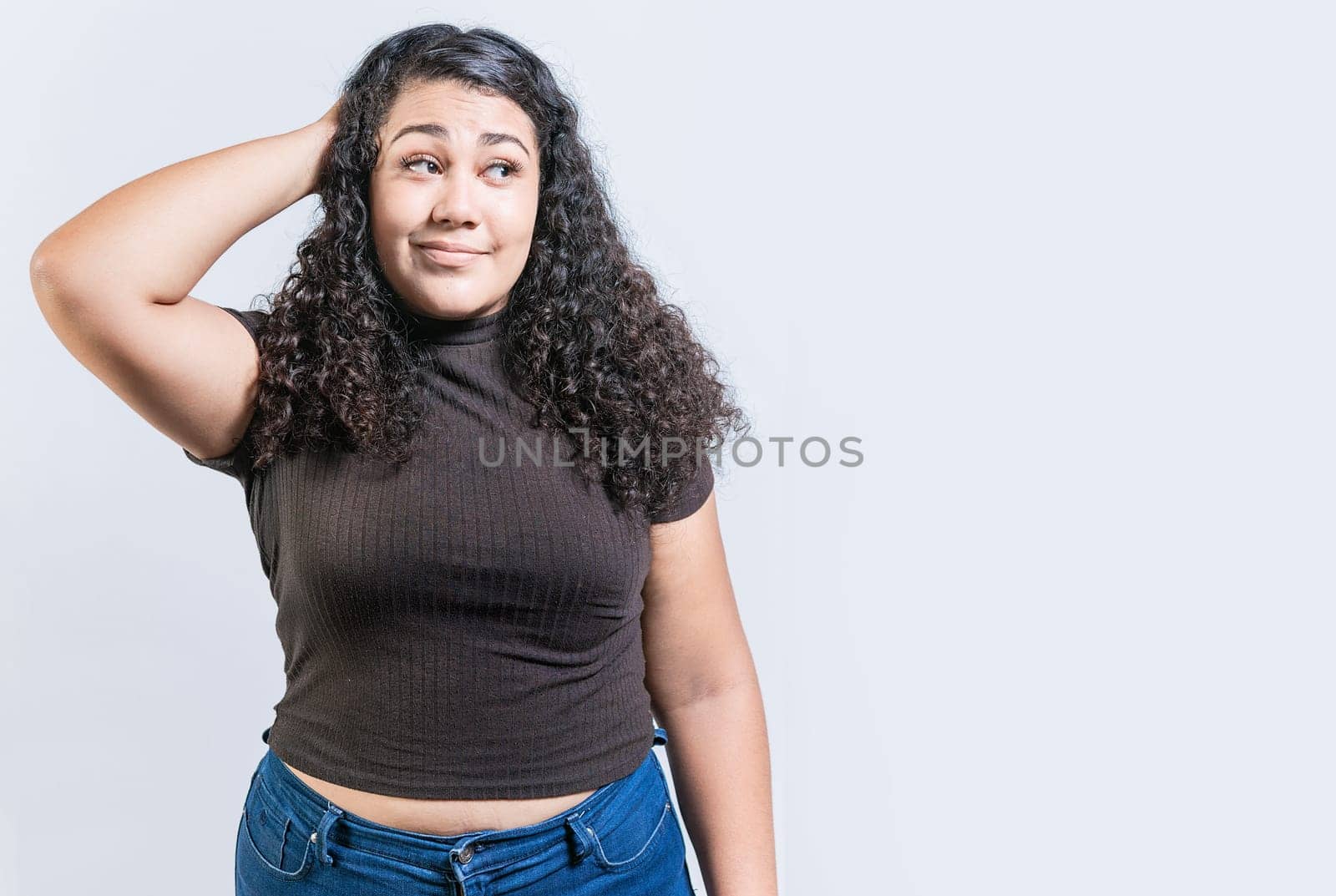 Young woman scratching her head with doubtful expression. People scratching heads with indecisive expression isolated by isaiphoto