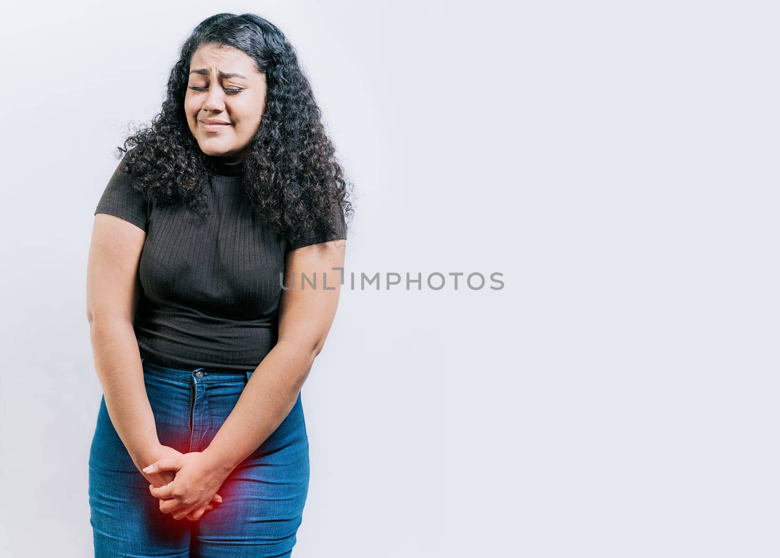 Young woman with urinary problems isolated. Girl with hands on crotch with urinary problems. People with urinary incontinence on white background by isaiphoto