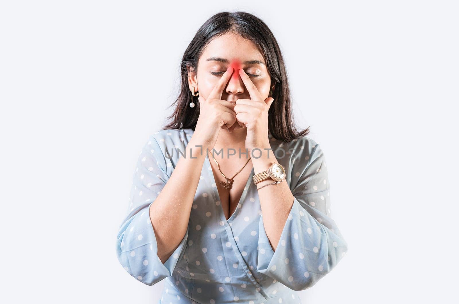 Girl with nasal bridge headache. Sinus pain concept. Young woman with pain touching nose. Person with nasal bridge pain