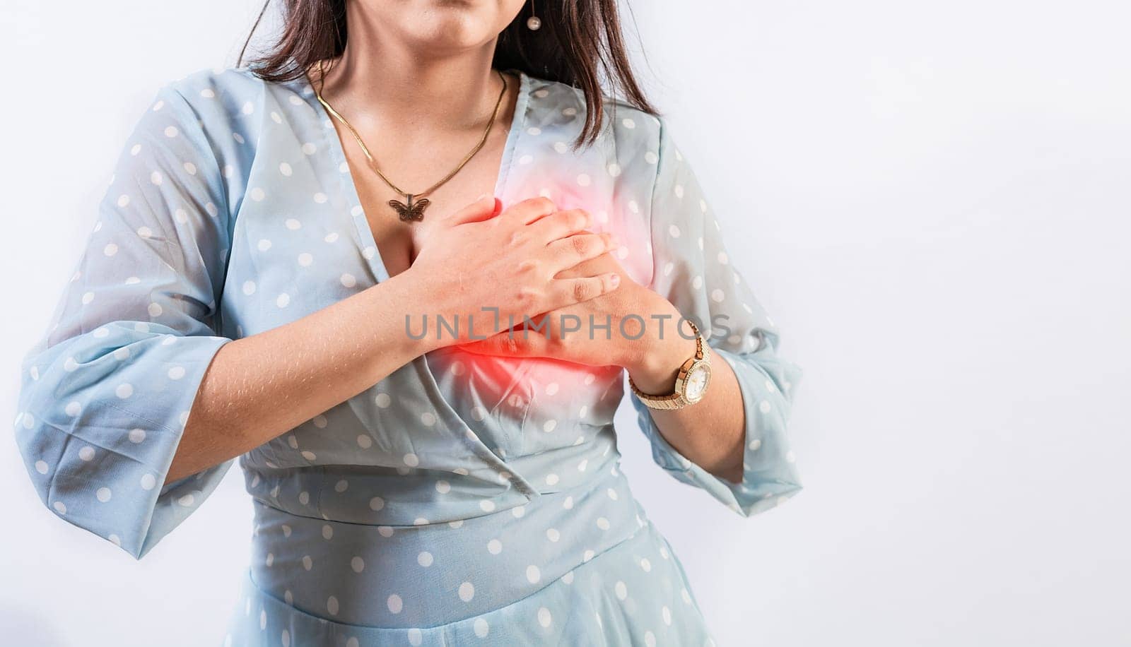 Unrecognizable woman with chest pain isolated. Girl with heart pain on isolated background. Concept of people with heart problems by isaiphoto