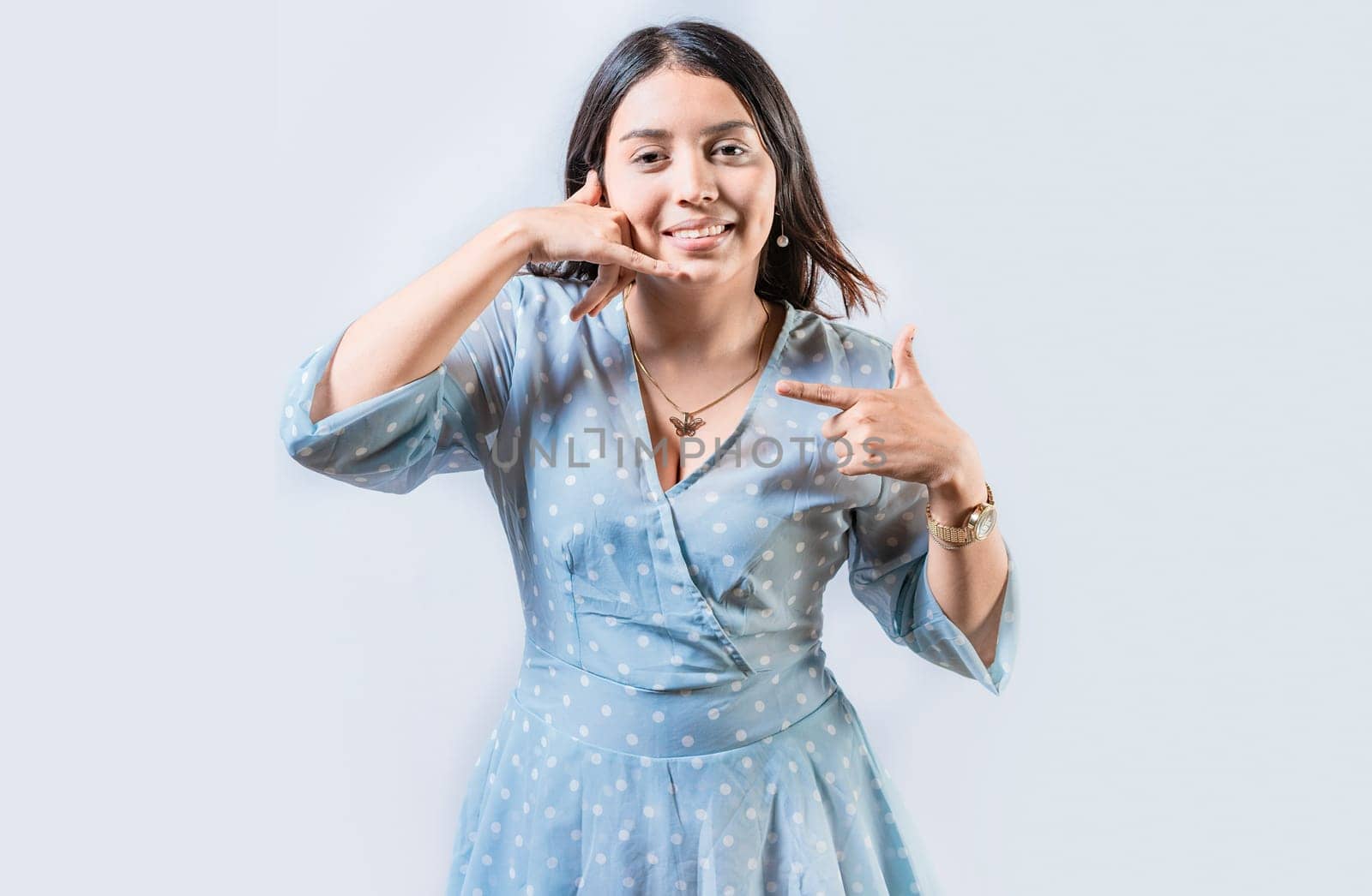 Young woman gesturing CALL ME in sign language isolated. Manual gestures of people with hearing problems by isaiphoto