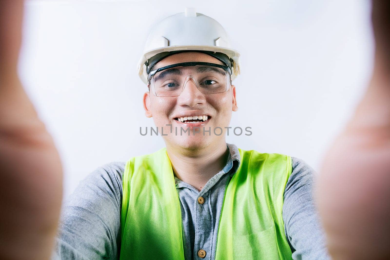 Smiling male engineer taking a selfie looking at camera. Cheerful builder engineer taking a selfie isolated, Engineer taking a selfie isolated