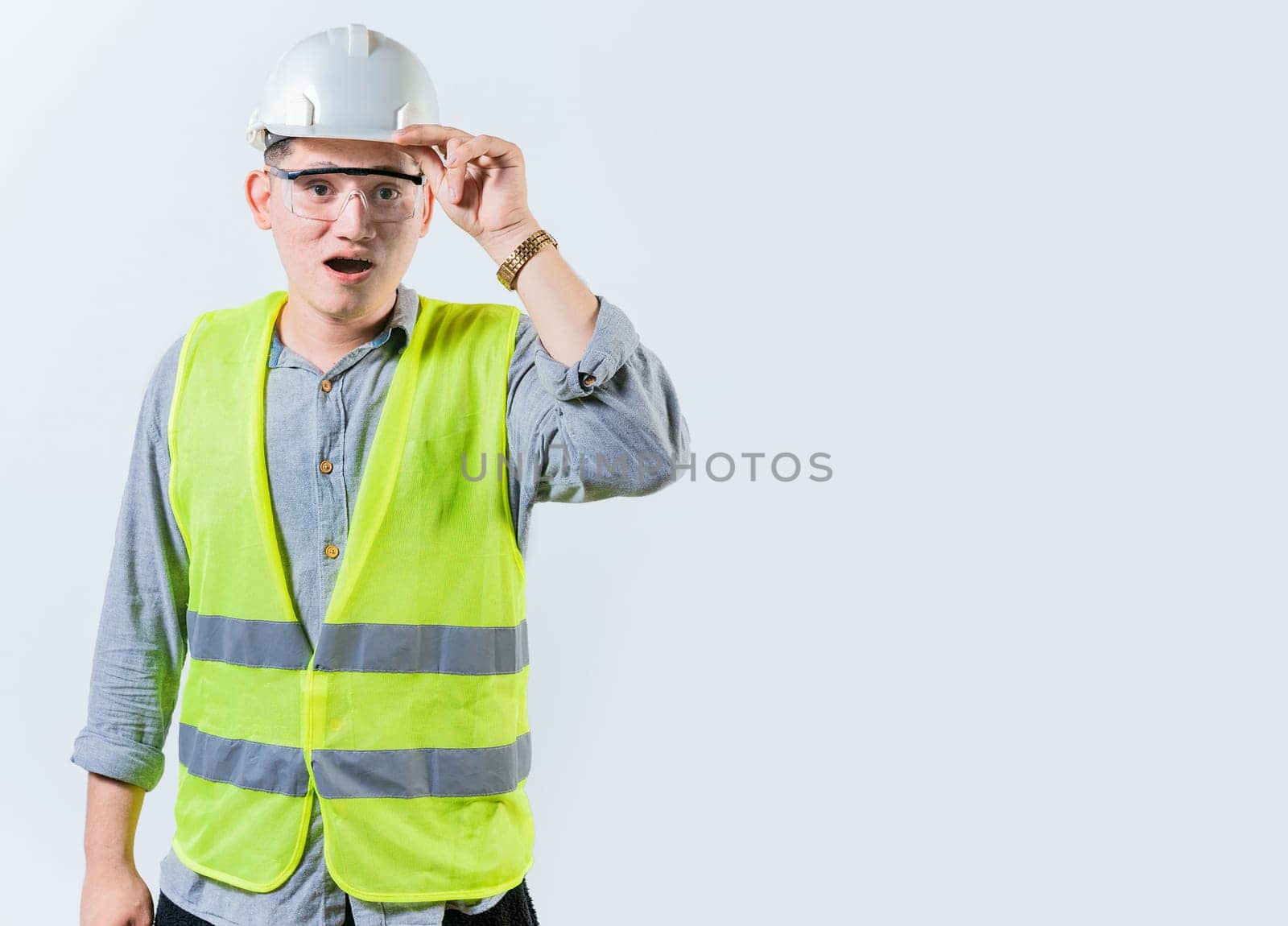 Amazed engineer looking into the distance isolated. Young engineer looking at something in the distance. Surprised man engineer looking into the distance by isaiphoto