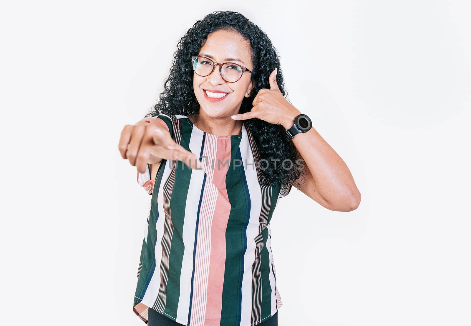Smiling young afro woman gesturing call me and pointing at camera. Happy girl gesturing call me with fingers isolated by isaiphoto