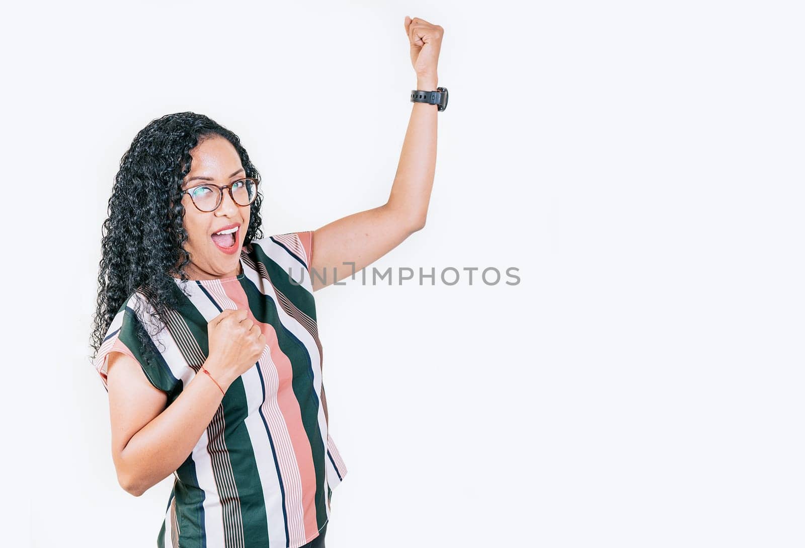 Excited afro girl raising arms celebrating victory. Happy young woman raising arms in victory gesture isolated. Winning people celebrating triumph by isaiphoto