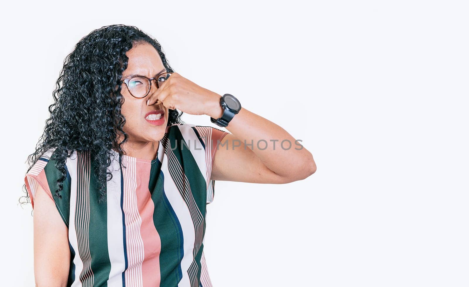  Afro woman covering her nose from a bad smell isolated. Displeased person holding her nose isolated. Disgust girl covering nose by isaiphoto