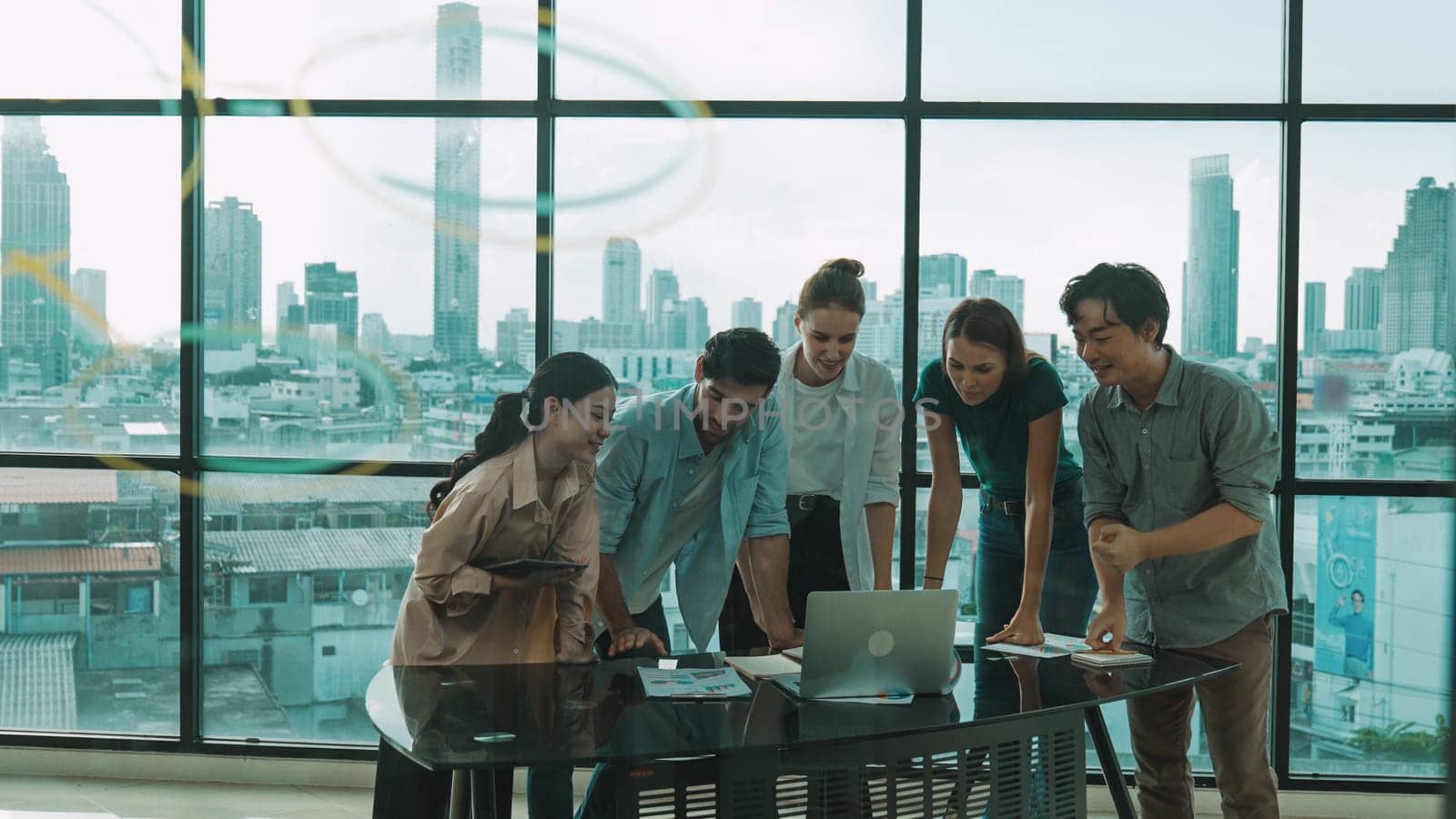 Group of diverse business people brainstorming about marketing plan. Multicultural business team working, talking, presenting about financial strategy with idea written on glass wall. Tracery