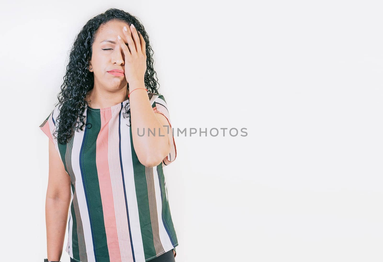 Stressed young woman holding her forehead. Stressed people with palm on forehead isolated. Worried young woman holding his forehead by isaiphoto