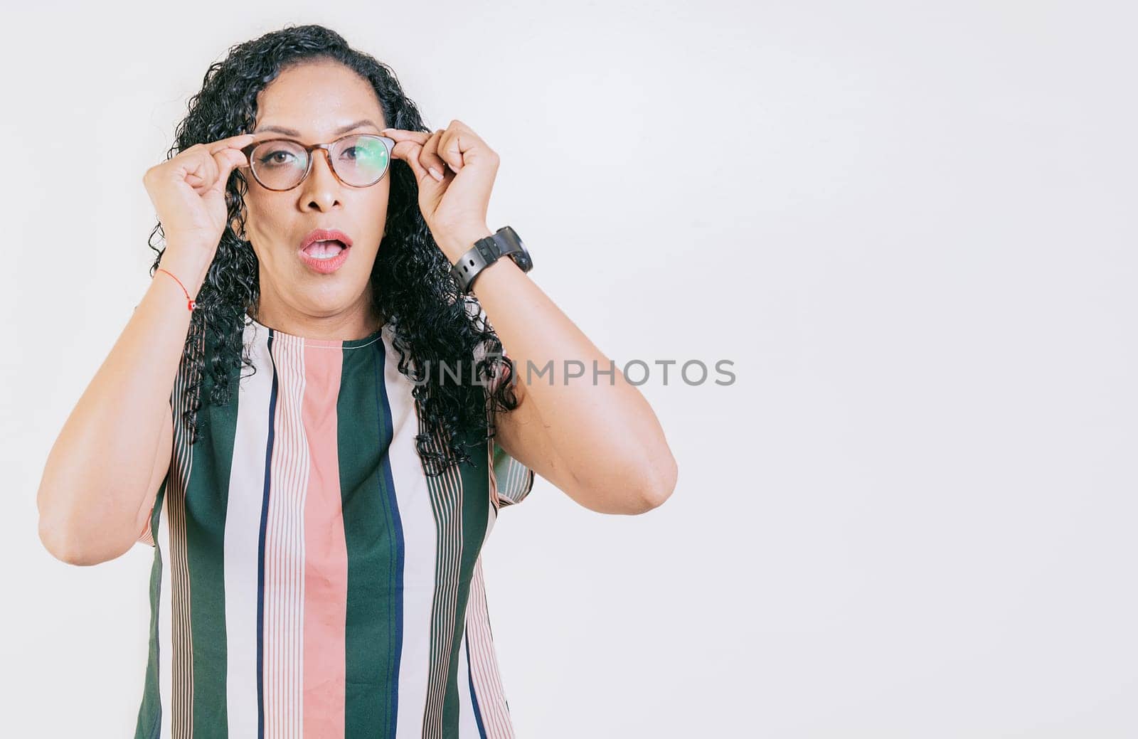 Surprised woman taking off glasses isolated. Amazed afro girl taking off glasses by a promotion, man opening his mouth surprised taking off his glasses by isaiphoto