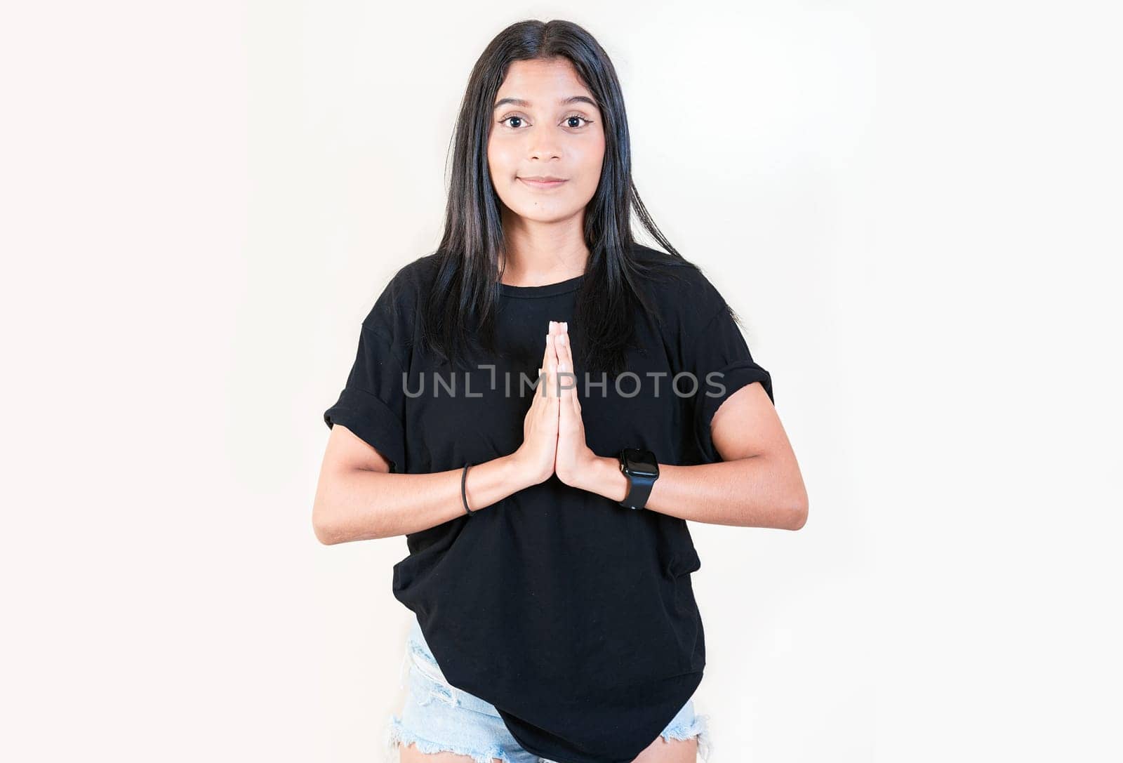 Beautiful young girl asking for a favor isolated. Latin girl asking for help with her hands isolated by isaiphoto