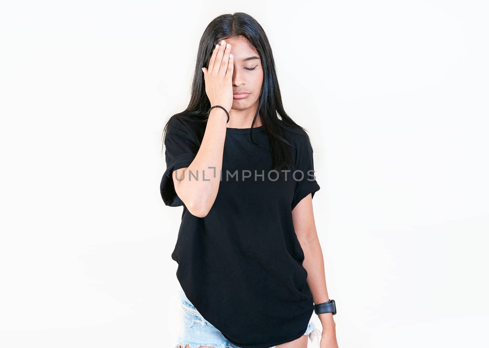 Worried young woman holding his forehead. Stressed people with palm on forehead isolated. Stressed young woman holding her forehead by isaiphoto