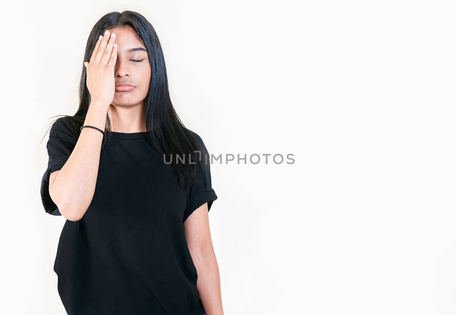Exhausted people with palm on forehead isolated. Tired and exhausted young girl holding her forehead. Worried young woman holding his forehead