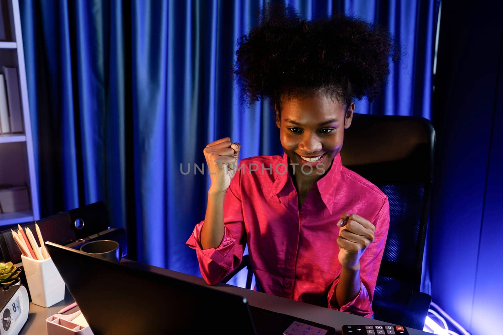 Working African woman with happy glowing, smiling face, getting new job project with good deal or marketing course scholarship information on laptop screen. Concept of cheerful expression. Tastemaker.