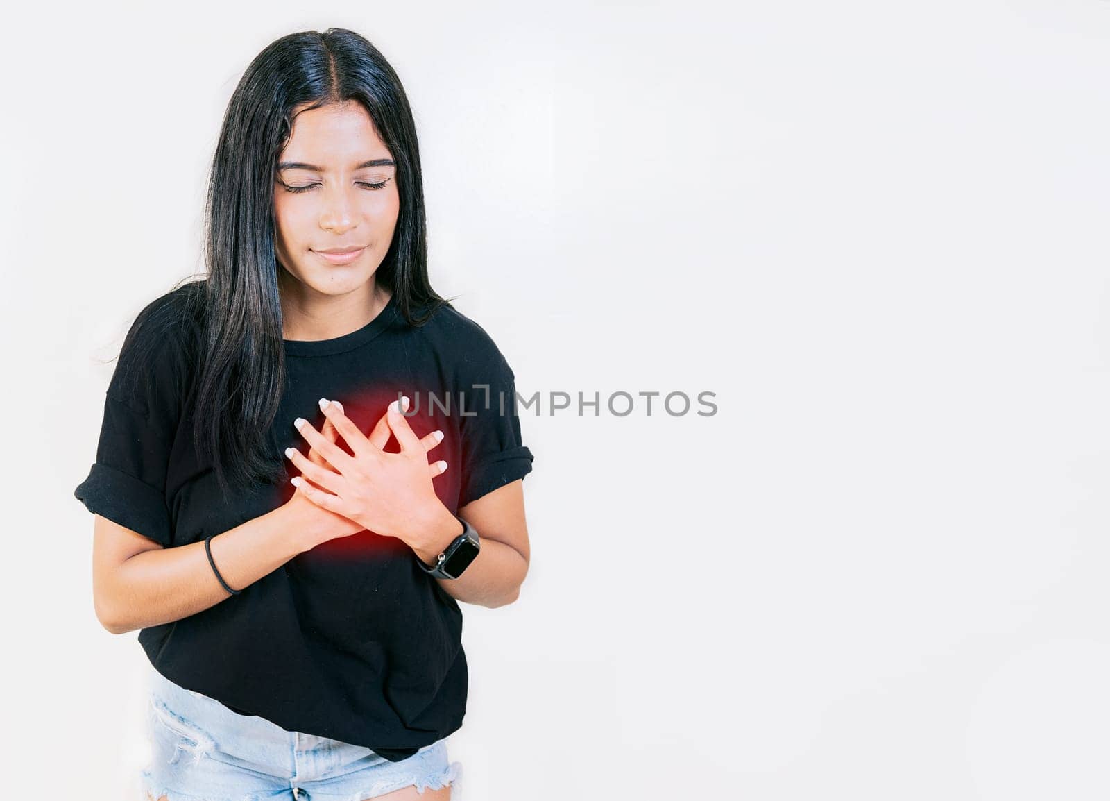 Young woman with tachycardia. Concept of people with heart problems. Latin woman with heart pain on isolated background by isaiphoto