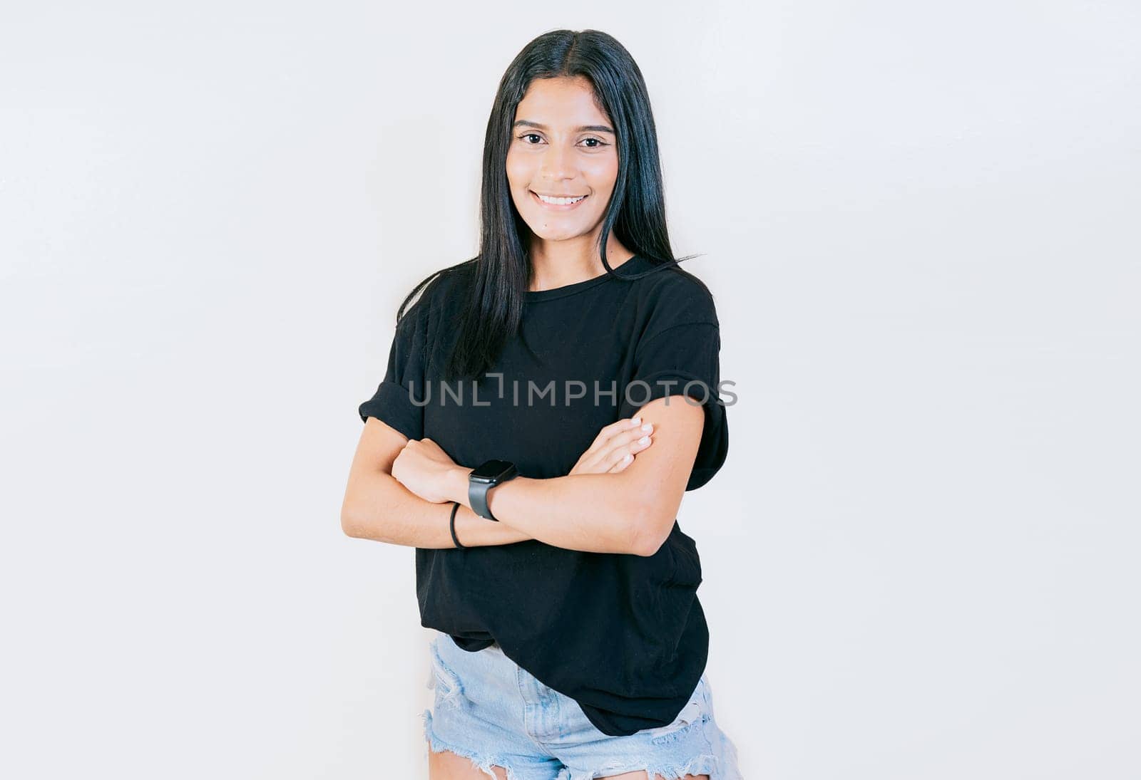 Portrait of beautiful latin girl with arms crossed. Smiling latin girl with arms crossed isolated. Nicaraguan woman on isolated background by isaiphoto