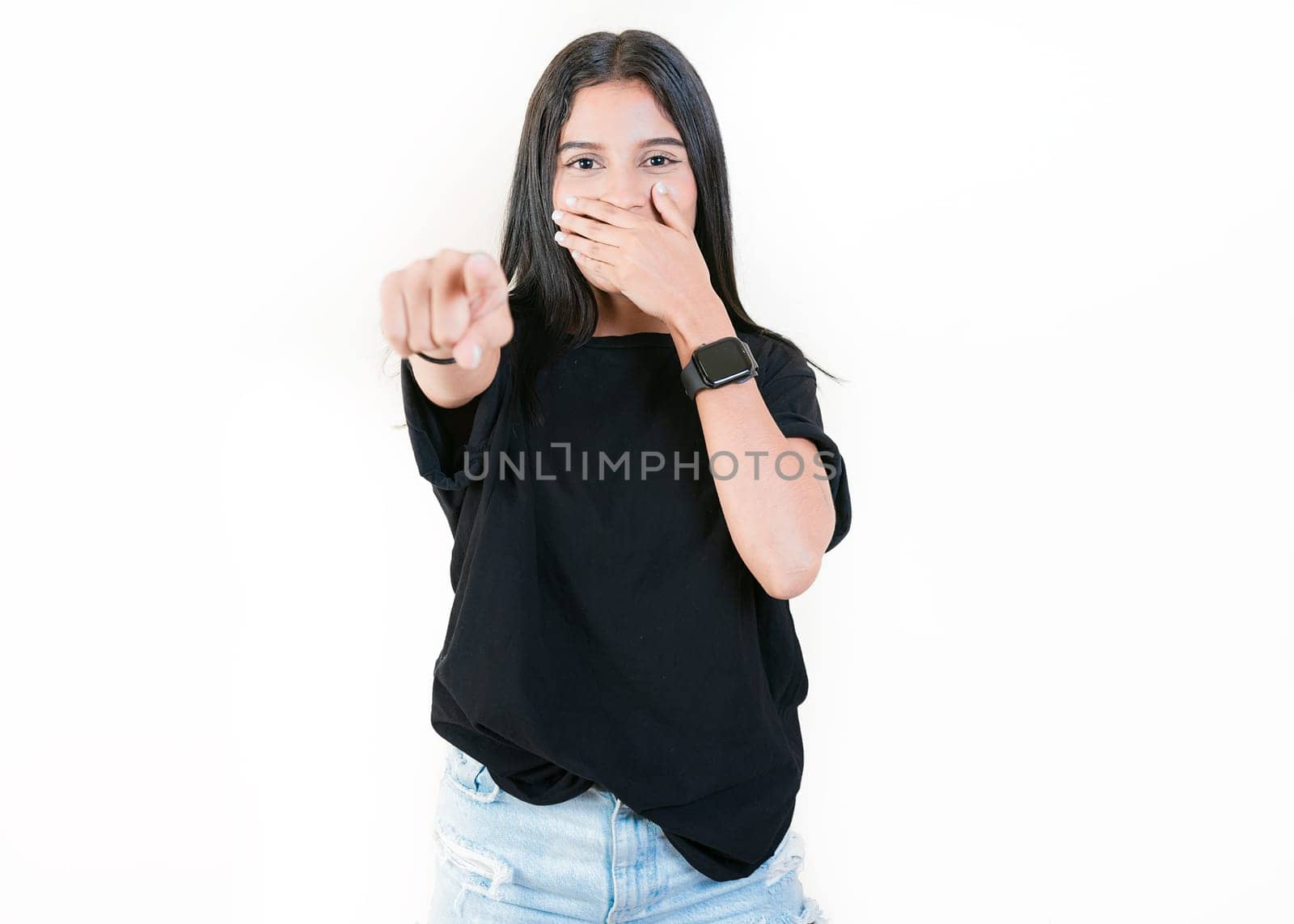 Girl laughing at you pointing at the camera, isolated. Young woman mocking and laughing at you isolated