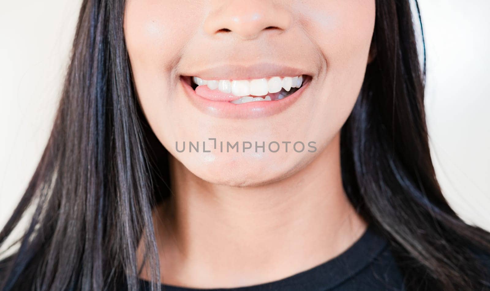 Close up of sexy girl biting tongue. Girl mouth biting her tongue isolated by isaiphoto
