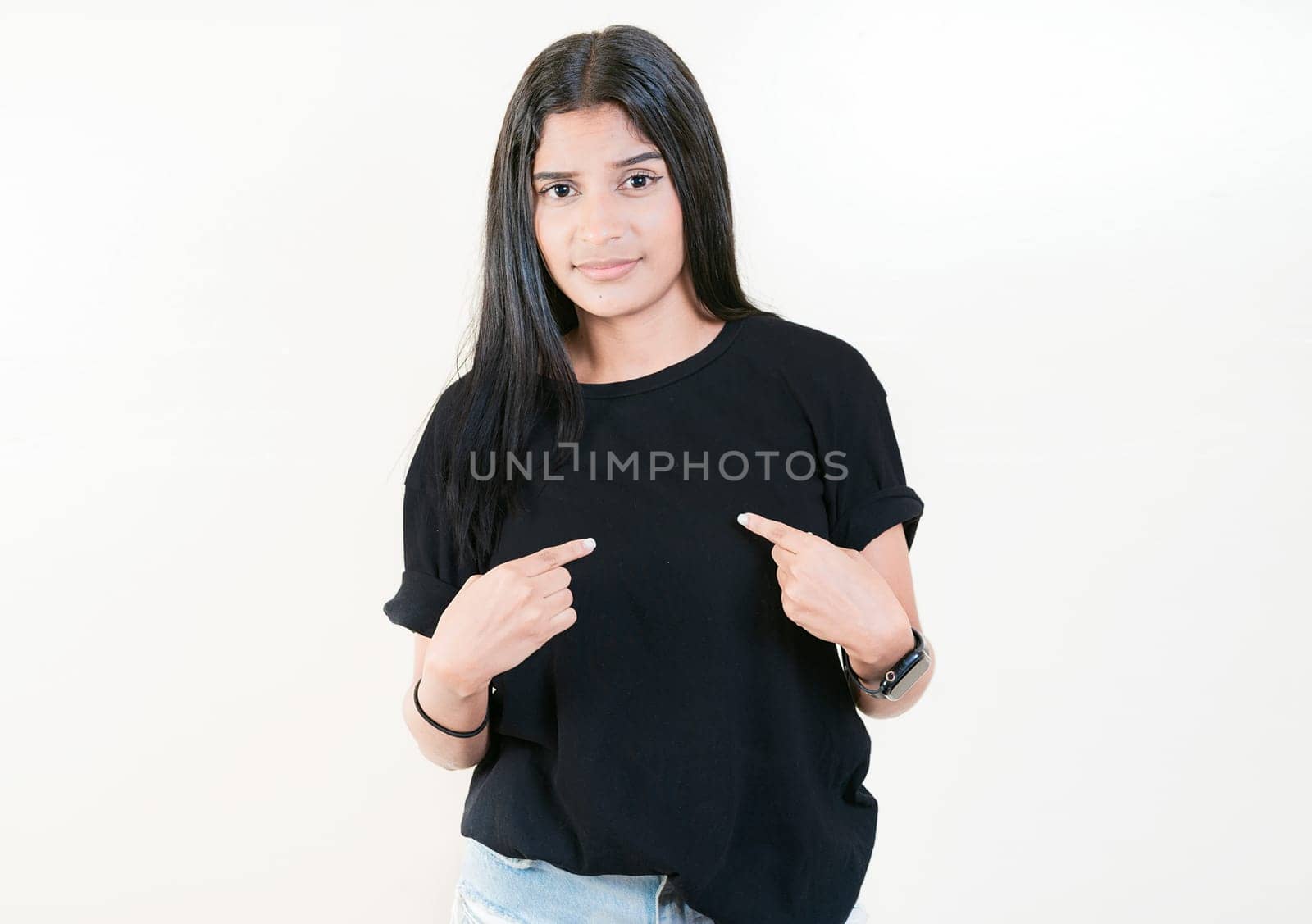 Embarrassed young woman pointing at herself isolated. Confused girl pointing at herself isolated by isaiphoto