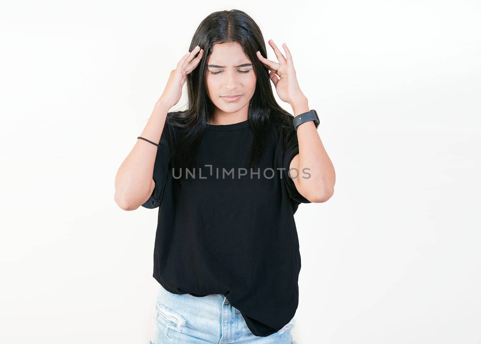 Tired and worried girl holding his forehead. Worried people isolated. Tired latin girl holding his head by isaiphoto