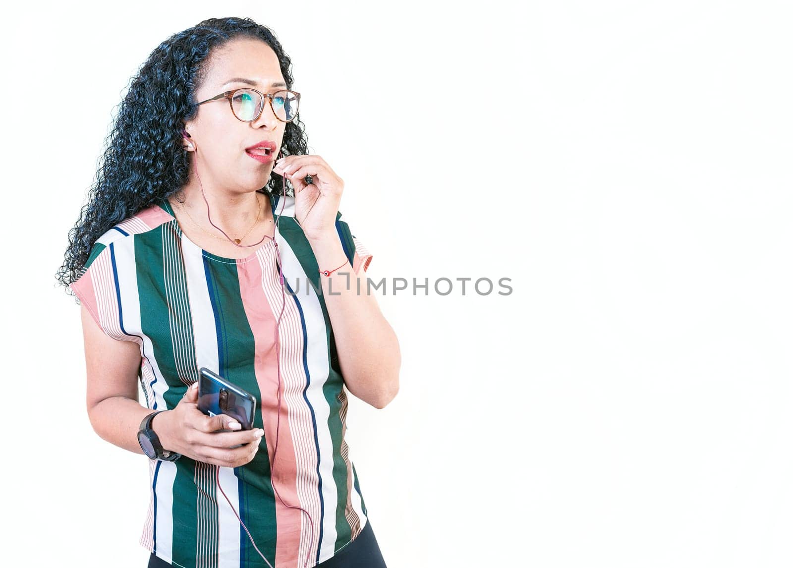 Young afro woman calling on the phone with earphones isolated by isaiphoto