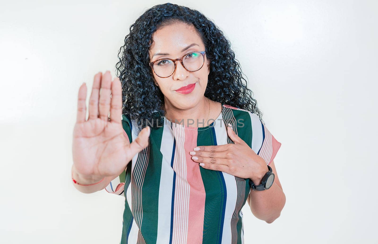 Afro girl gesturing stop isolated. Latin girl gesturing stop with palm hand isolated. Young afro woman rejecting with the palm hand isolated