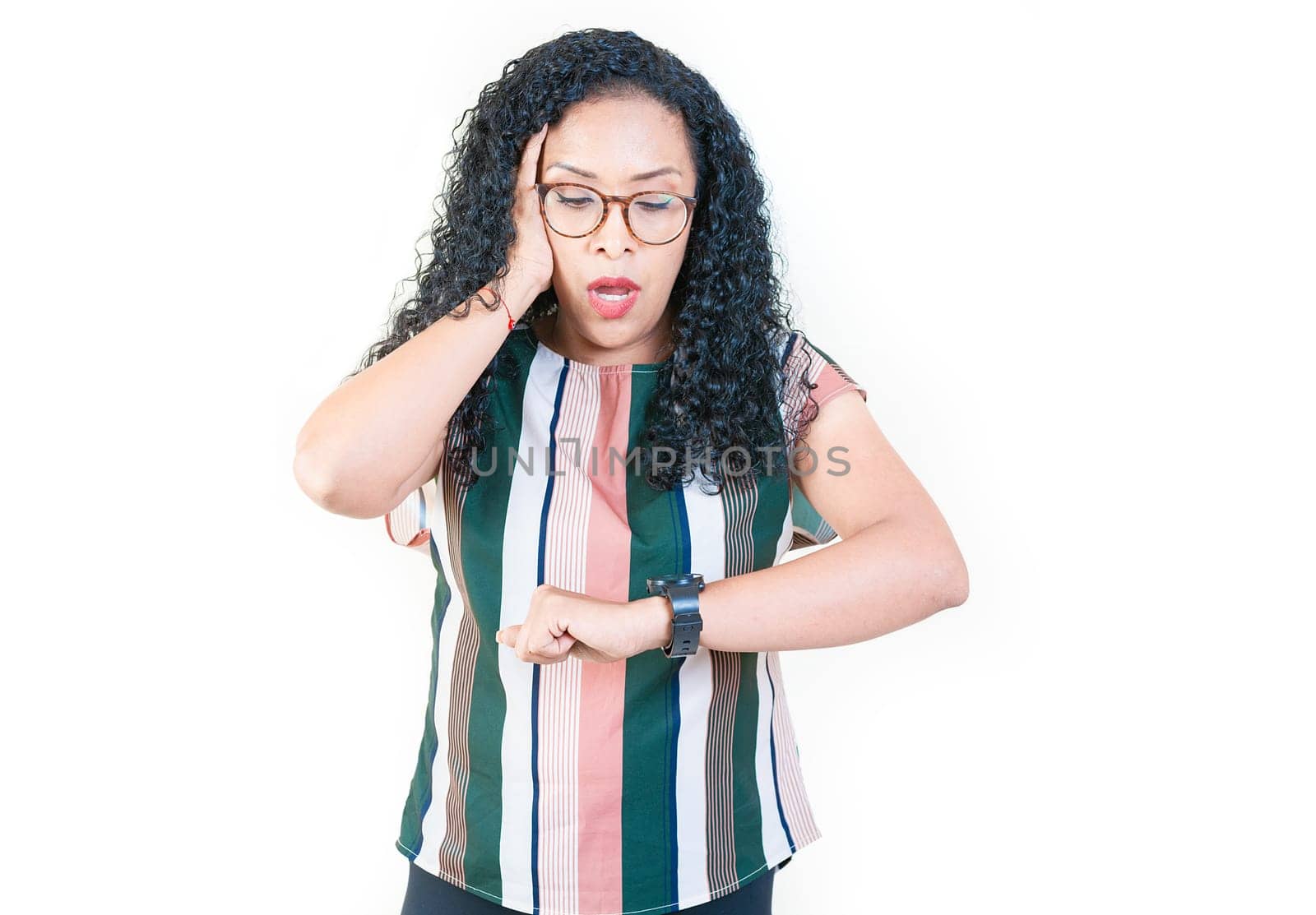 Surprised afro young woman looking at wrist watch. Worried afro girl looking at her watch isolated by isaiphoto