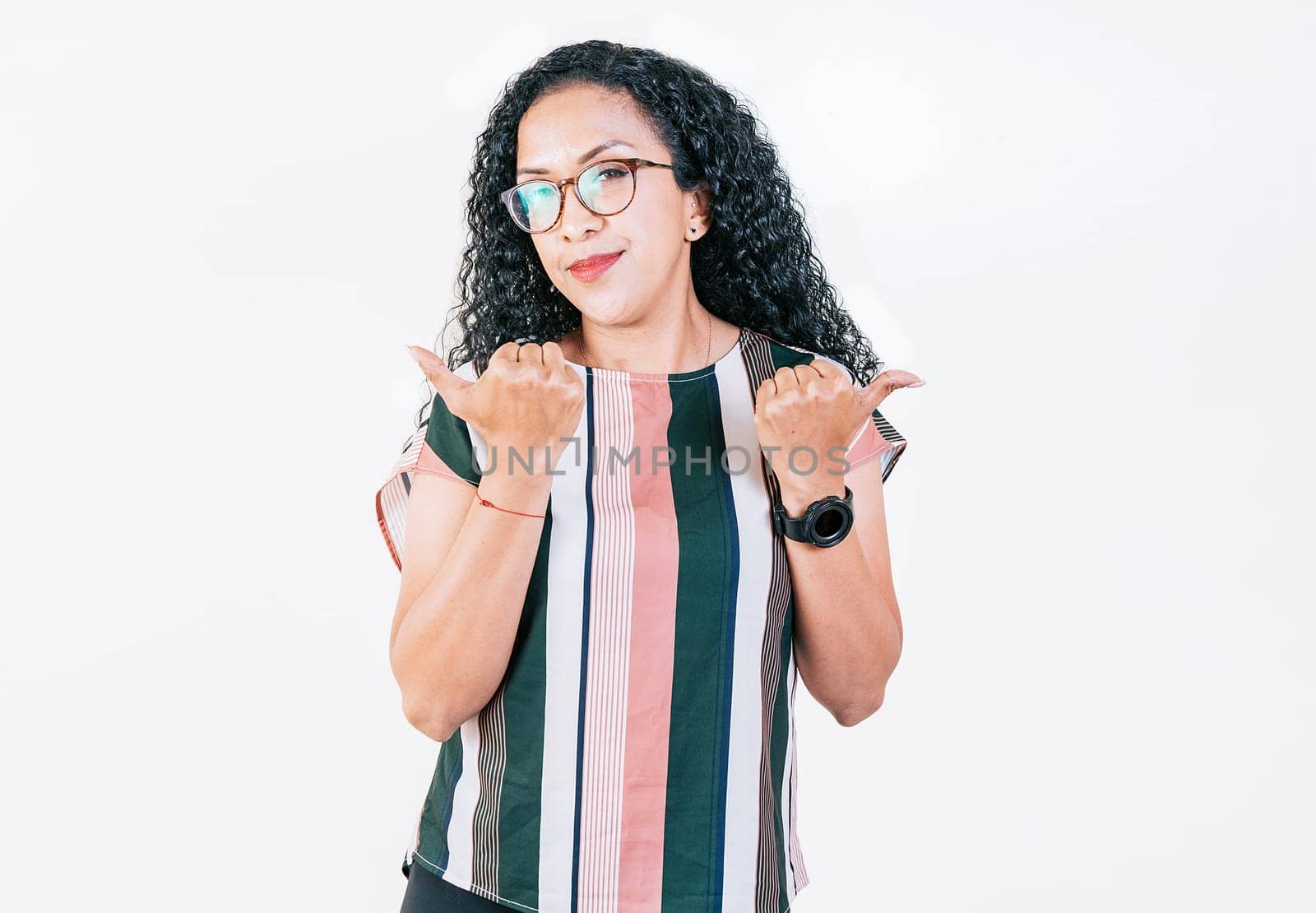 Beautiful afro young woman pointing an offer with both fingers. Smiling afro girl pointing both sides on isolated background. Cheerful girl recommending with fingers