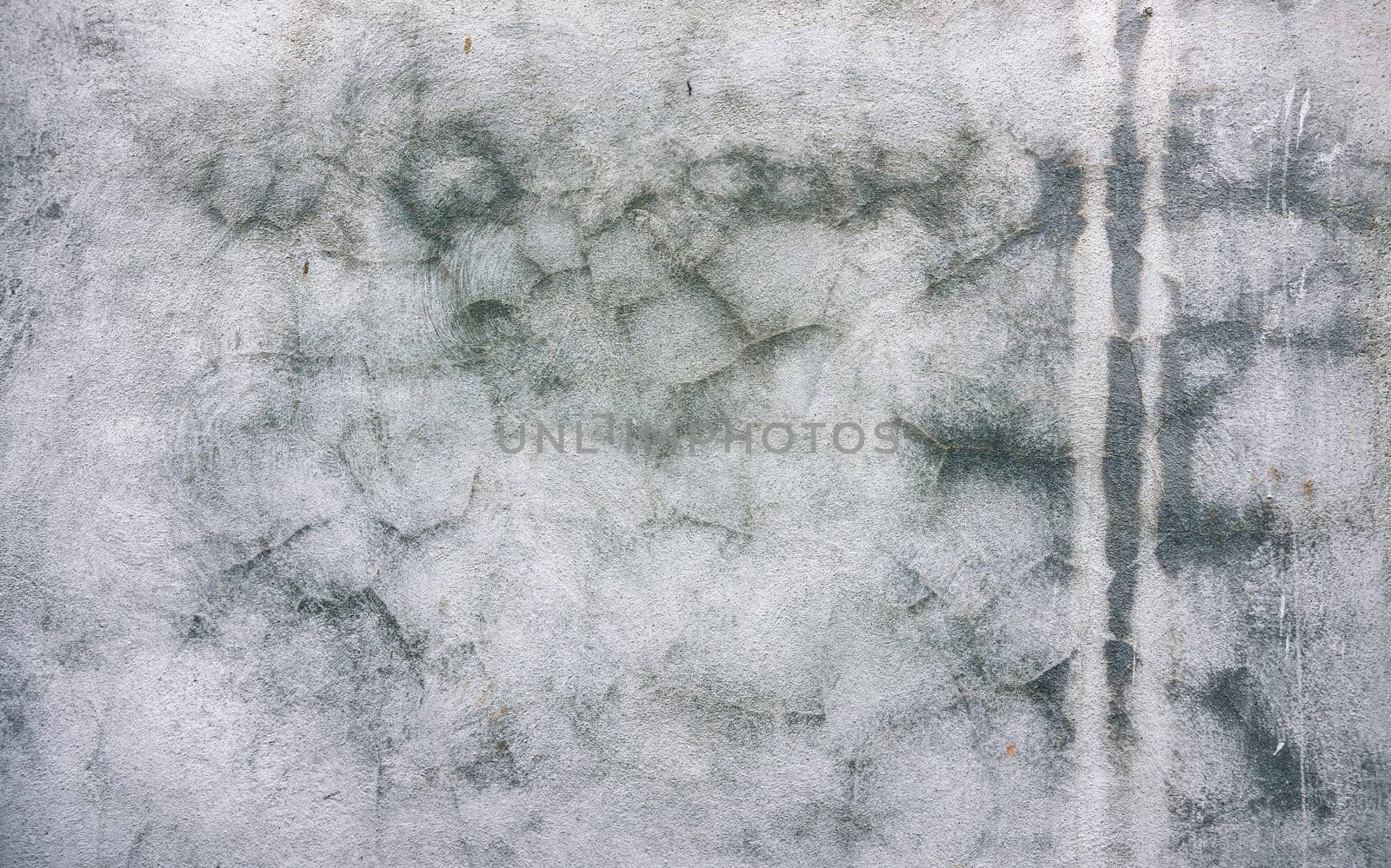 View of textured and cracked wall. Textured old wall background. Texture of a gray wall. Old wall with cracked texture. Cracked cement wall background