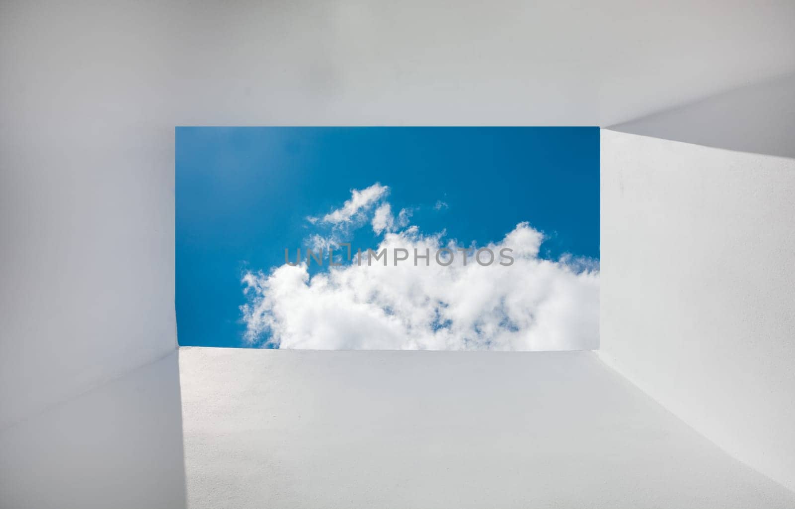 Perspective of clouds from frame shaped walls. perspective of sky and clouds from white walls. White walls with clouds and sky in the background in the form of a frame by isaiphoto