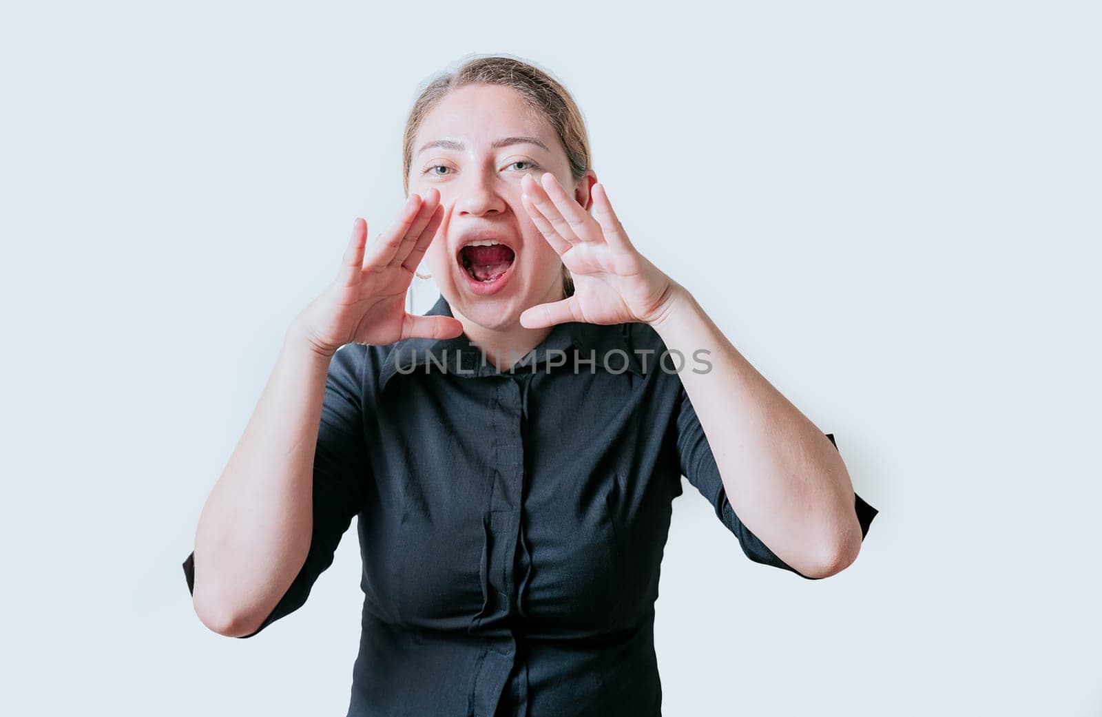 Female teenager announcing something to the camera. Young girl screaming and announcing at the camera by isaiphoto