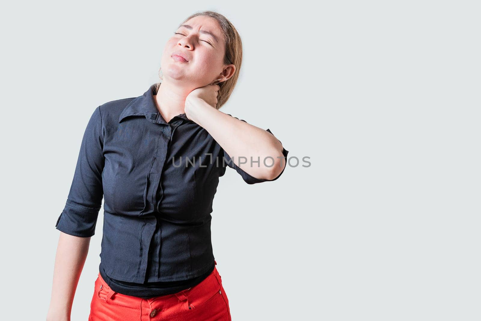 Young woman with muscle tension and neck pain isolated. Stress and neck pain concept, Girl suffering from neck pain isolated by isaiphoto