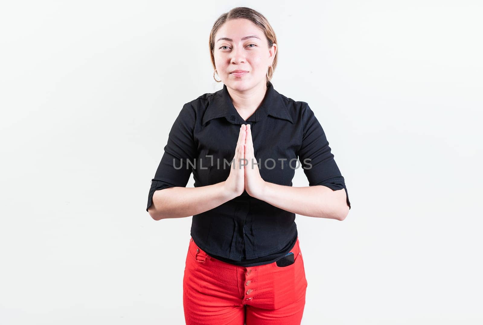 Attractive young woman asking for a favor isolated. Latin girl asking for help with her hands isolated by isaiphoto
