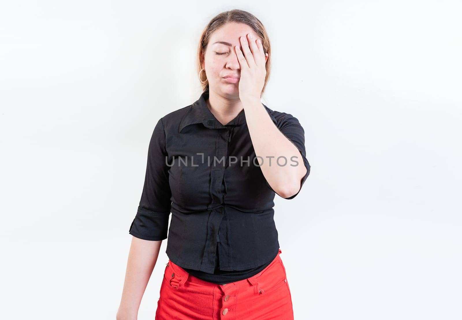 Exhausted woman with palm on forehead isolated. Tired and exhausted young girl holding her forehead. Worried young woman holding his forehead by isaiphoto