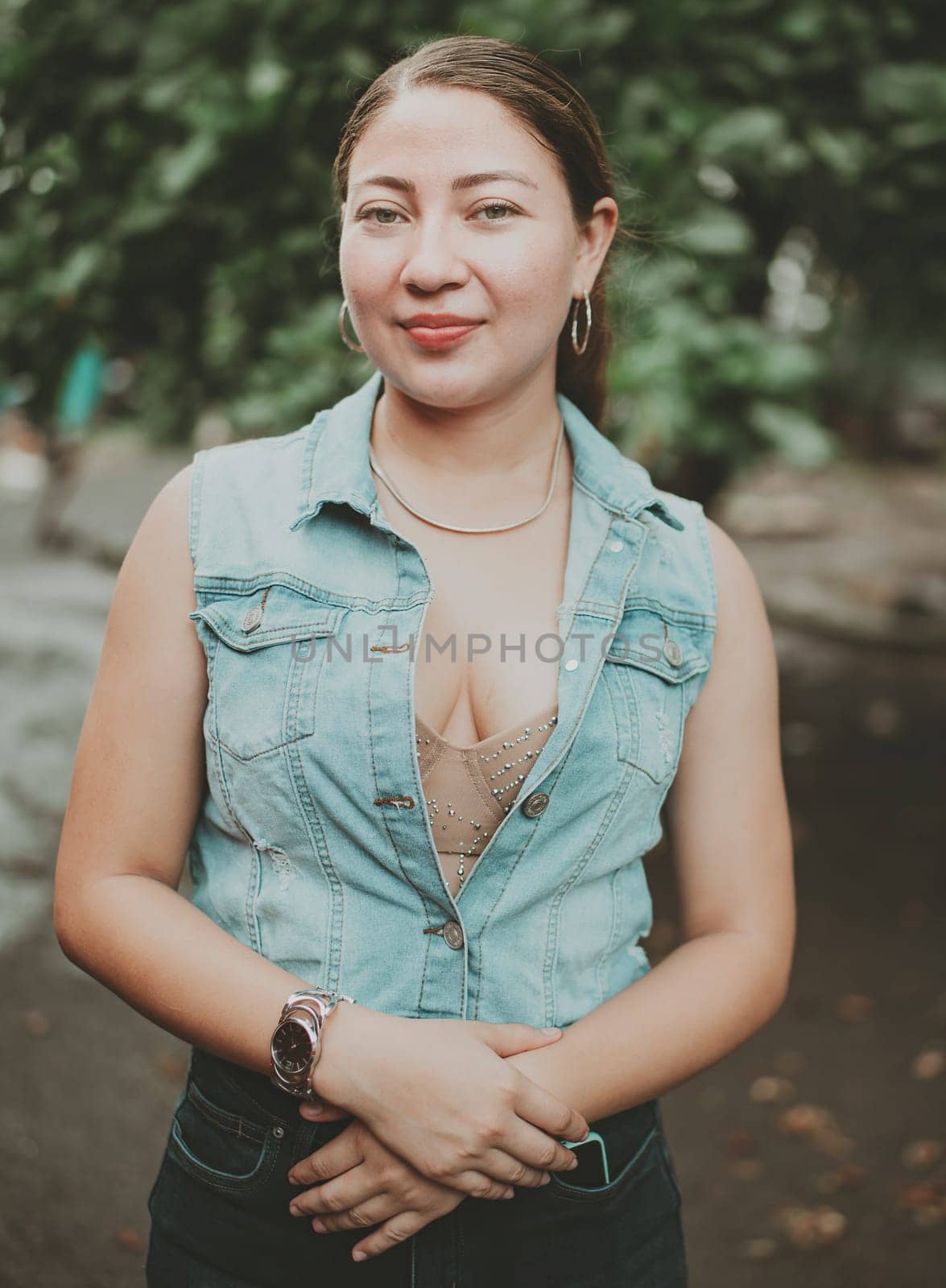 Portrait of attractive latin girl smiling outdoors. Portrait of Latin American girl face looking and smiling at the camera. Portrait of young Nicaraguan woman smiling at camera by isaiphoto