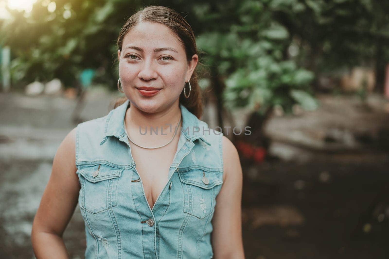 Portrait of Latin American girl face looking and smiling at the camera. Portrait of young Nicaraguan woman smiling at camera. Portrait of attractive latin girl smiling outdoors by isaiphoto