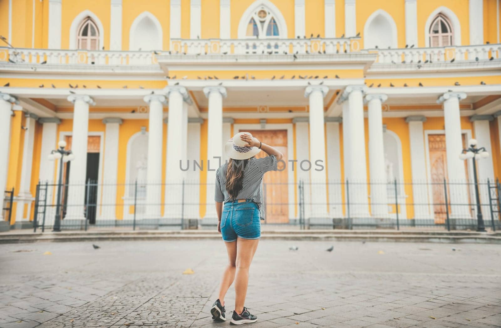 Tourism in Nicaragua, Tourist girl visiting the Granada cathedral. Travel girl looking at the Catholic church in Granada, Nicaragua
