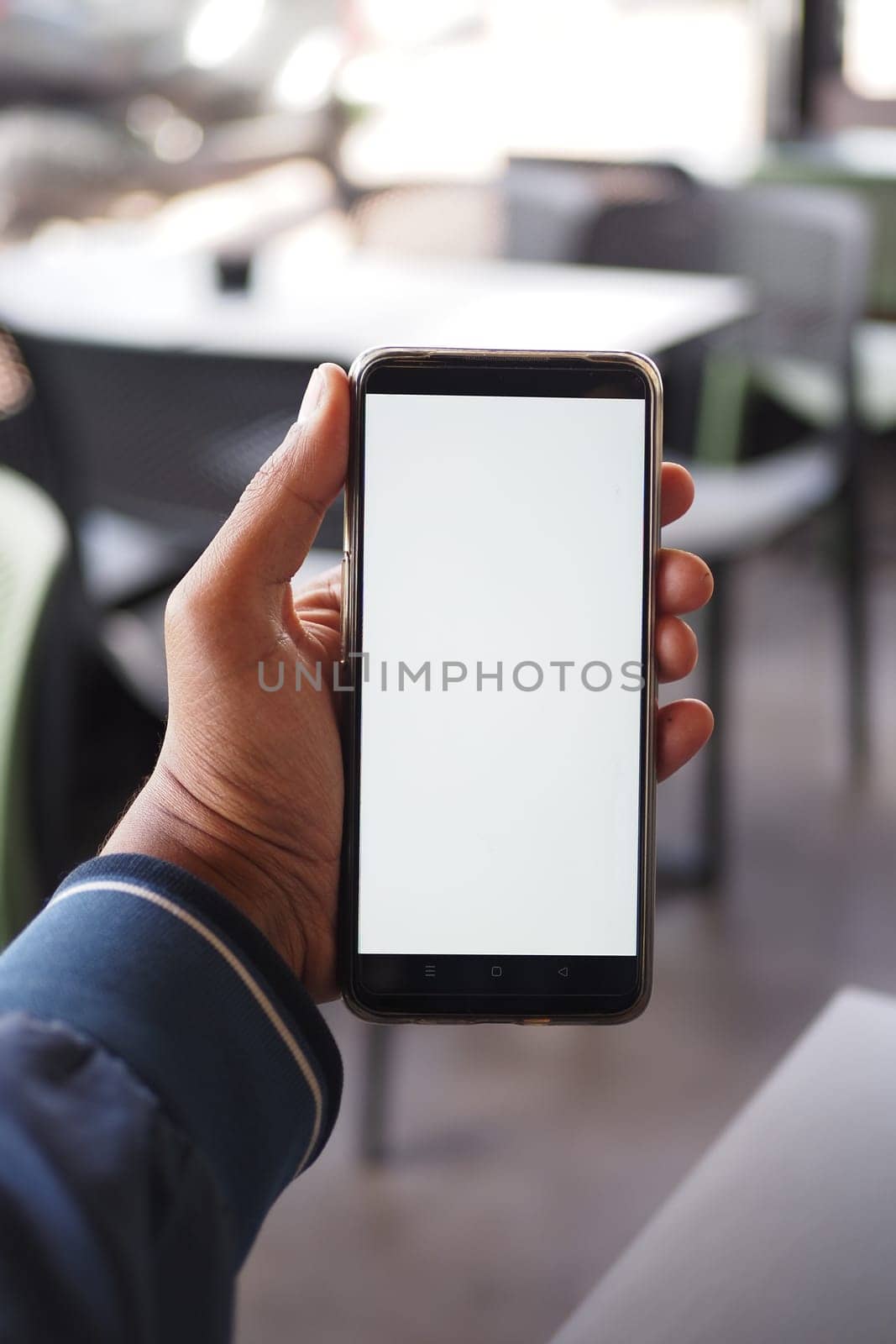 Close up of young man hand using smart phone