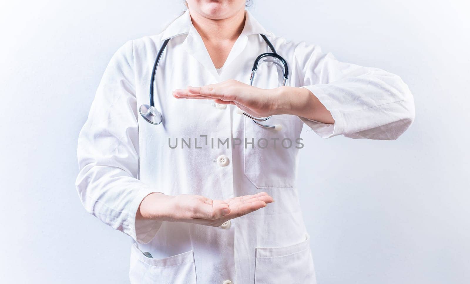 Female doctor hands presenting something isolated. Hands of female doctor holding something isolated by isaiphoto