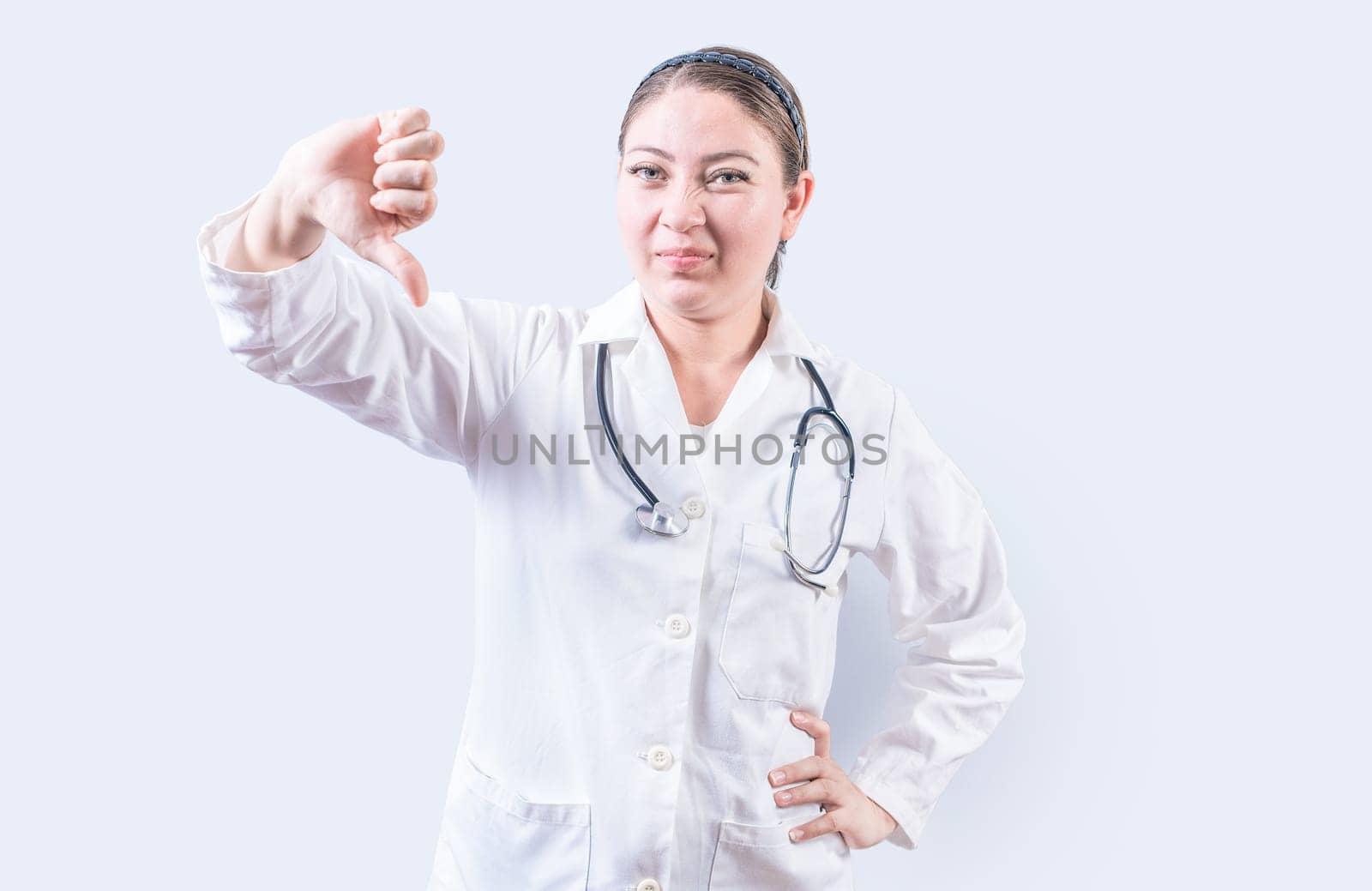 Female doctor gesturing disapproval isolated. Female doctor disapproving with fingers isolated
