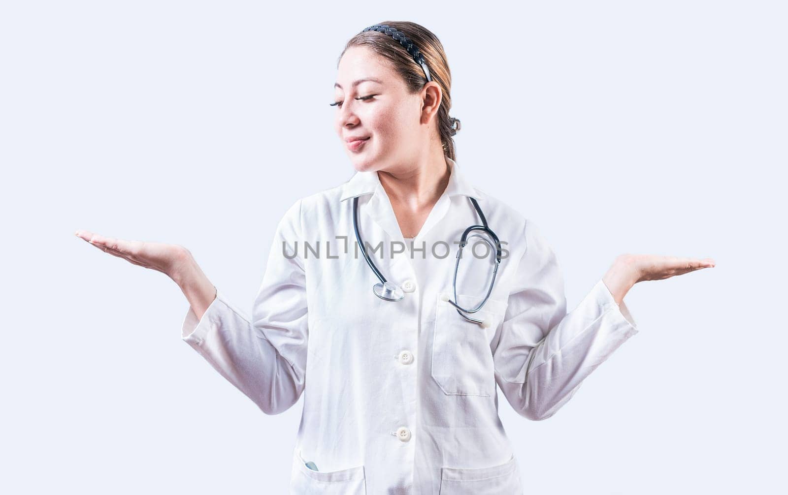 Female doctor presenting something with both palms. Young female doctor showing something with both palms isolated by isaiphoto