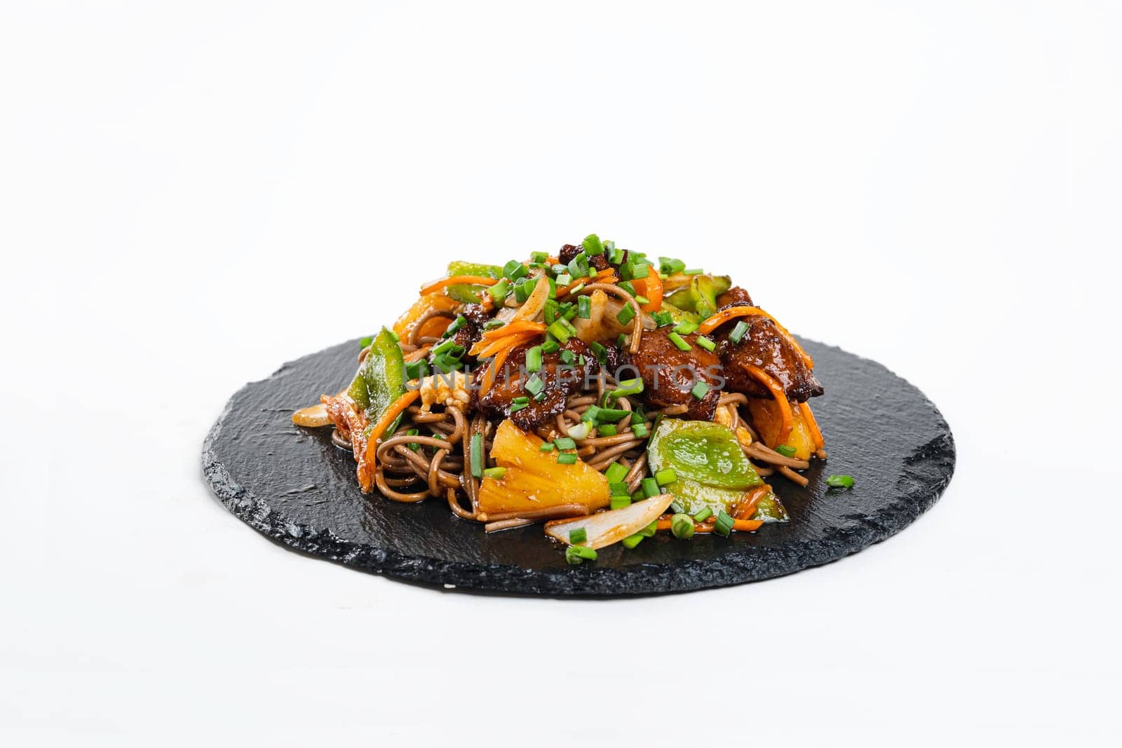 fried assorted vegetables with meat in a flat plate on a white background, side view by tewolf