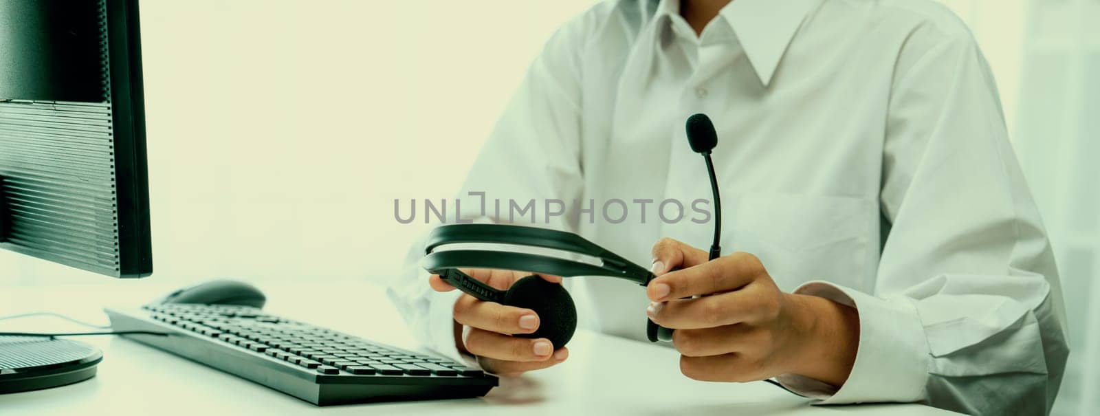 Call center wearing headset working in office for customer support oratory by biancoblue