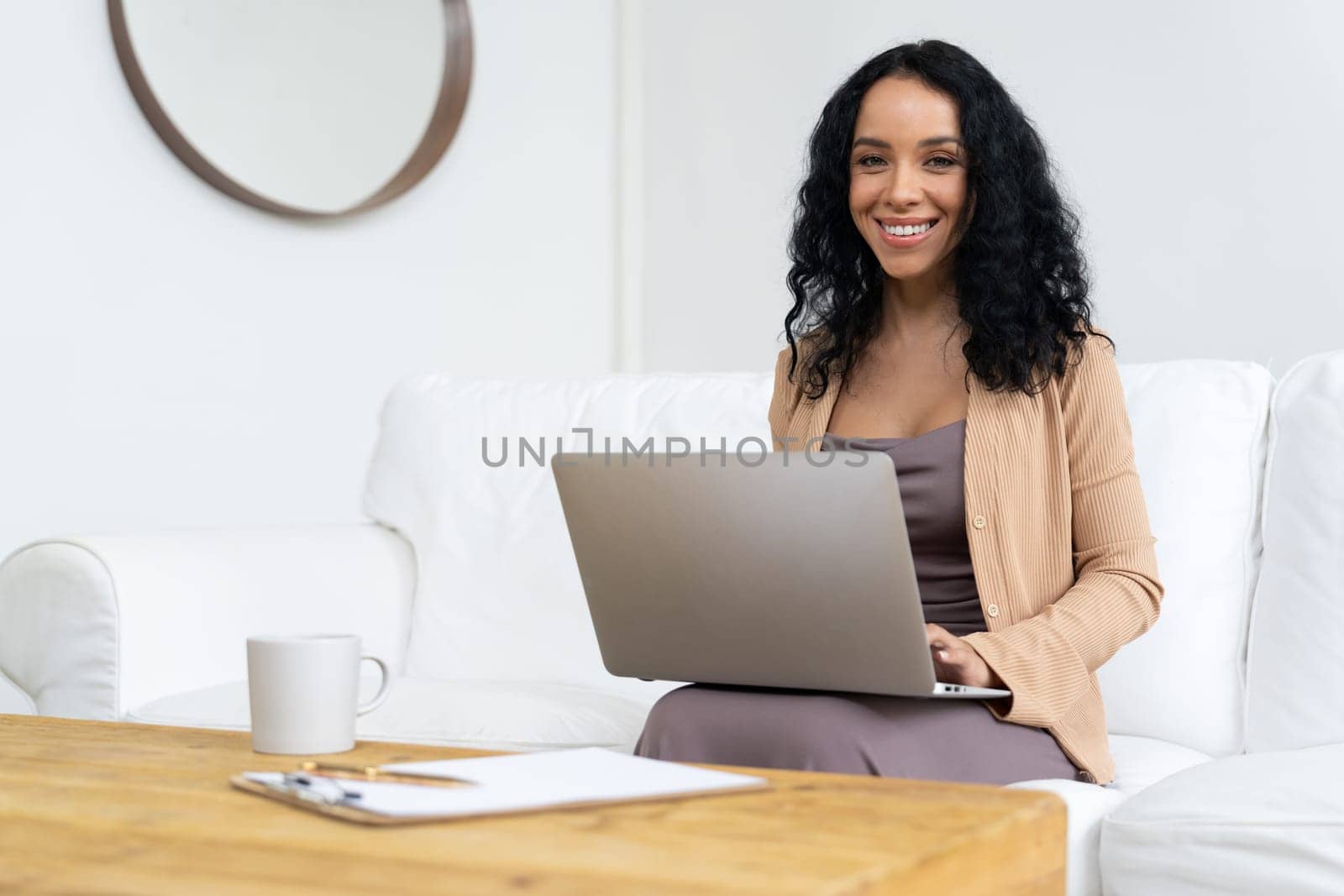 African-American woman using laptop computer for crucial work on internet. Secretary or online content writing working at home.