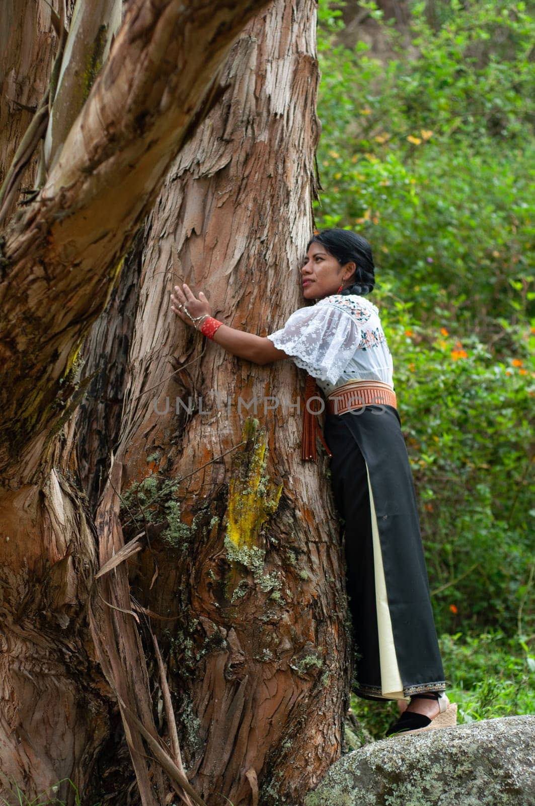 indigenous environmentalist embracing an ancient tree in a moment of spiritual connection and vitality.EARTH DAY by Raulmartin