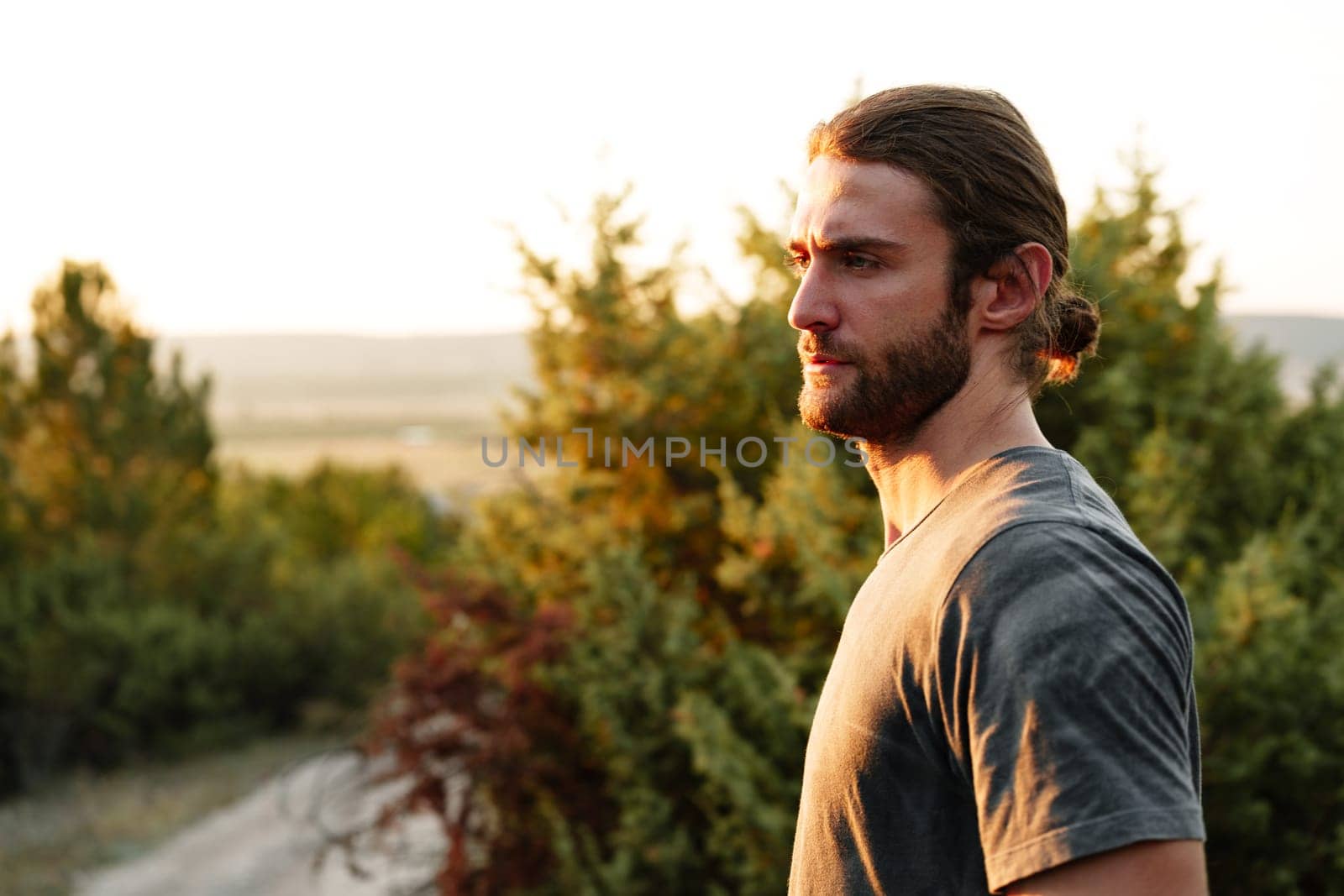Casual man hiker outdoors in gray T-shirt outdoors portrait by Fabrikasimf