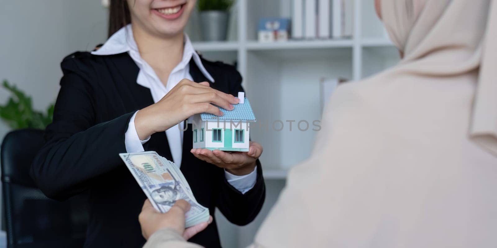 A real estate agent offers a house to a female Muslim client. The concept of buying and selling houses and real estate..